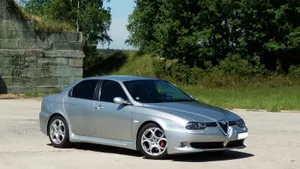 Sleek Black Alfa Romeo 156 In An Urban Setting Wallpaper