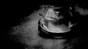 Sleek Black And White Sports Car On A Highway Wallpaper