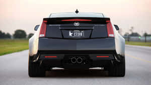 Sleek Black Cadillac Ats On The Highway Wallpaper