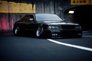 Sleek Black Car Tunnel Scene Wallpaper