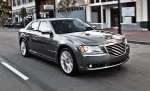 Sleek Black Chrysler 300 Cruising On The Highway Wallpaper