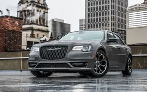 Sleek Black Chrysler 300 On The Open Road Wallpaper