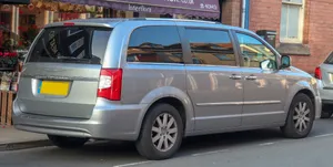 Sleek Black Chrysler Voyager On The Road Wallpaper