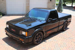 Sleek Black Gmc Syclone Speeding On The Highway Wallpaper