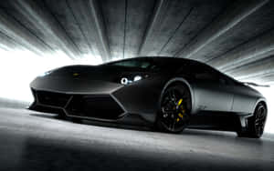 Sleek Black Lamborghini Murciélago In The Spotlight Wallpaper