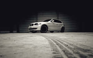 Sleek Bmw 1 Series On The Road Wallpaper