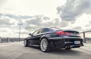 Sleek Bmw 6 Series Gliding Through The City Streets Wallpaper