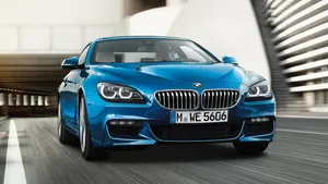 Sleek Bmw 6 Series In A Vibrant Urban Setting Wallpaper