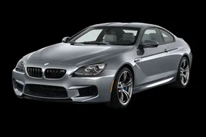 Sleek Bmw M6 Sportscar On A Scenic Mountain Road Wallpaper