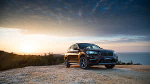 Sleek Bmw X1 In Horizon Glow Wallpaper