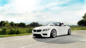 Sleek Bmw Z4 Roadster Cruising On The Open Road Wallpaper