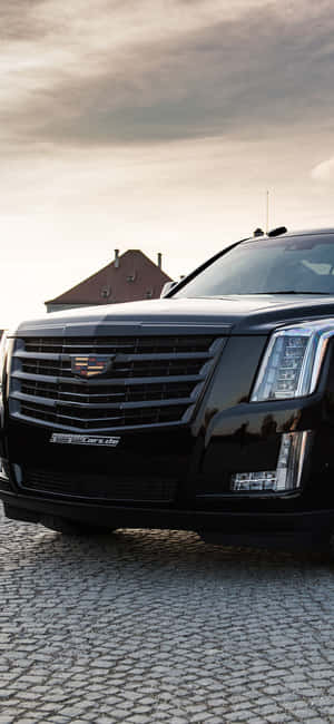 Sleek Cadillac Escalade On The Road Wallpaper