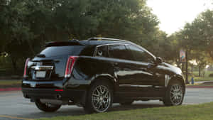 Sleek Cadillac Srx Driving On Open Road Wallpaper