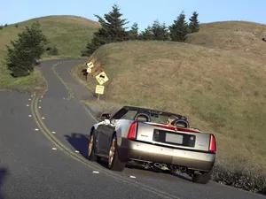 Sleek Cadillac Xlr Cruising The Streets Wallpaper