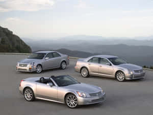 Sleek Cadillac Xlr In Vibrant Sunset Wallpaper