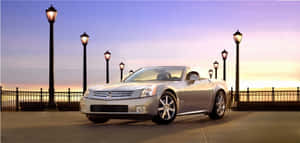 Sleek Cadillac Xlr On Display In A Stunning Outdoor Setting Wallpaper