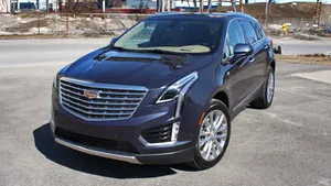 Sleek Cadillac Xt5 Luxury Suv In Action Wallpaper
