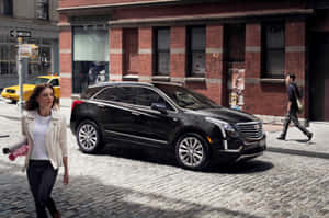 Sleek Cadillac Xt5 On An Open Road Wallpaper