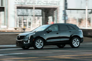 Sleek Cadillac Xt5 On Open Road Wallpaper