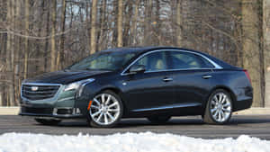 Sleek Cadillac Xts Gliding Through The City Streets Wallpaper