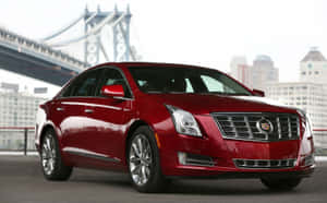 Sleek Cadillac Xts In A Vibrant Urban Setting Wallpaper