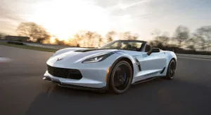 Sleek Chevrolet Corvette Grand Sport Cruising Down The Highway Wallpaper