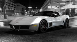Sleek Chevrolet Corvette Stingray Cruising Down An Open Road Wallpaper