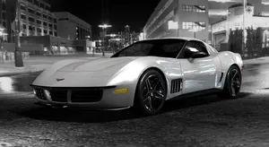 Sleek Chevrolet Corvette Stingray Cruising Down An Open Road Wallpaper