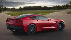 Sleek Chevrolet Corvette Stingray Cruising On The Road Wallpaper