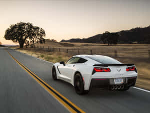 Sleek Chevrolet Corvette Stingray On Open Road Wallpaper