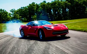 Sleek Chevrolet Corvette Stingray Roaring On The Open Road Wallpaper