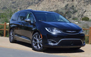 Sleek Chrysler Pacifica Driving On A Serene Highway Wallpaper