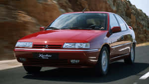 Sleek Citroen Xantia Parked Under Clear Blue Sky Wallpaper