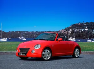 Sleek Daihatsu Car On An Open Road Wallpaper