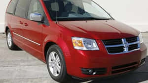 Sleek Dodge Grand Caravan On Open Road Wallpaper