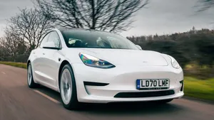 Sleek Electric Vehicle Charging At A Station Wallpaper