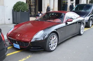 Sleek Ferrari 612 Scaglietti Cruising On A Scenic Highway Wallpaper