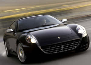 Sleek Ferrari 612 Scaglietti On An Open Road Wallpaper