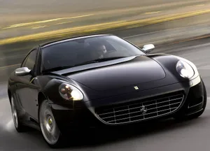 Sleek Ferrari 612 Scaglietti On An Open Road Wallpaper