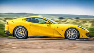 Sleek Ferrari 812 Superfast On An Open Road Wallpaper