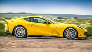 Sleek Ferrari 812 Superfast On An Open Road Wallpaper