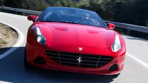 Sleek Ferrari California T In A Scenic Drive Wallpaper