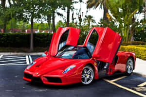 Sleek Ferrari Enzo Gliding On The Open Road Wallpaper