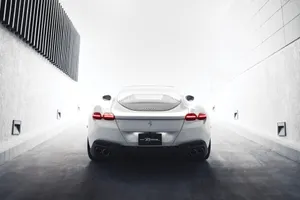 Sleek Ferrari Roma Cruising On The Open Road Wallpaper