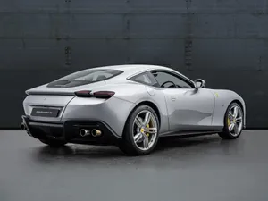 Sleek Ferrari Roma On Scenic Road Wallpaper