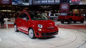 Sleek Fiat 500l Cruising On An Open Road Wallpaper