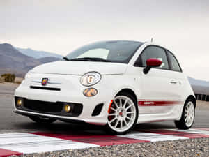 Sleek Fiat Cinquecento In Urban Setting Wallpaper