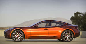 Sleek Fisker Electric Vehicle On Scenic Route Wallpaper