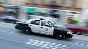 Sleek Ford Crown Victoria In A Vibrant Urban Setting Wallpaper