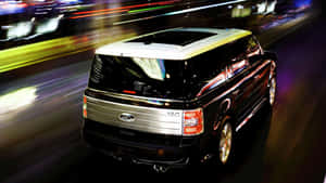 Sleek Ford Flex Cruising Through The City Streets. Wallpaper